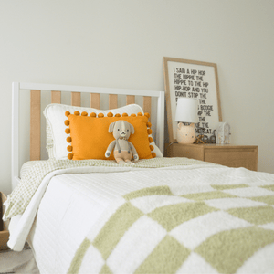 Natural wood twin over twin bunk bed with kid on ladder with playful bedroom decor