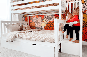 White wood twin over full bunk bed with storage drawers and kids on staircase
