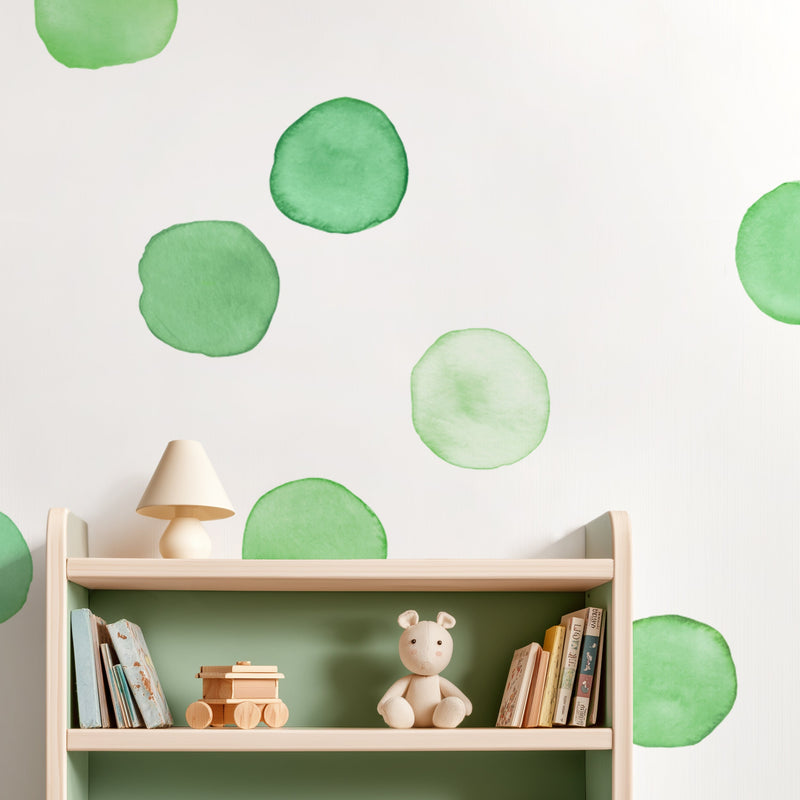 Nursery shelf with wooden toy train, plush bear, children's books and lamp on green watercolor polka dot wallpaper — minimalist Scandinavian nursery decor
