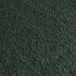Close-up macro of deep forest green textured upholstery fabric swatch with soft pile and woven pattern