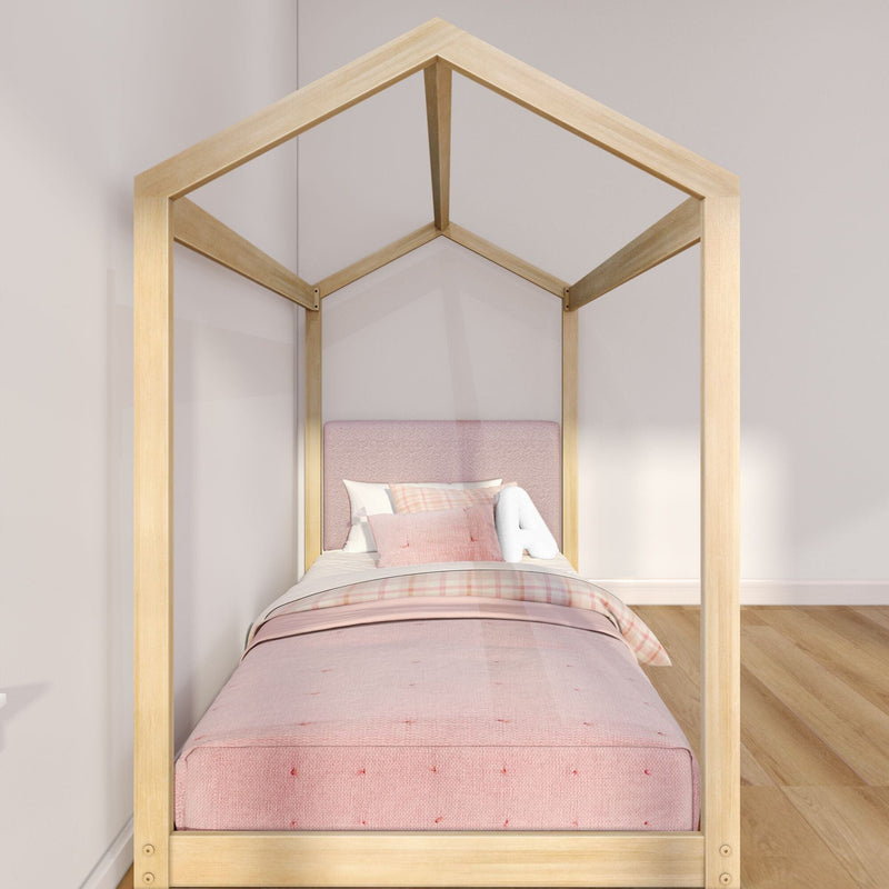 Minimalist wooden house-frame children's bed with pink bedding and plaid pillows in a modern bedroom with hardwood floors