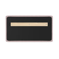 Pink fabric‑framed wall bulletin board with black felt surface and centered wooden mounting strip secured by screws