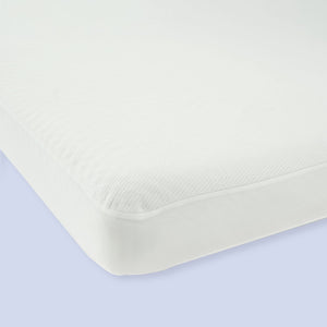High-quality white mattress close-up, featuring a soft and breathable fabric cover for enhanced comfort.