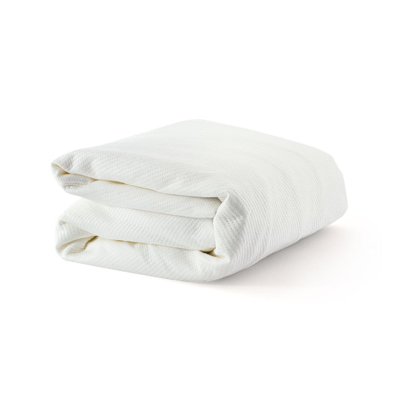 Folded white cotton blanket on a white background, luxury bedding item for comfort and warmth.