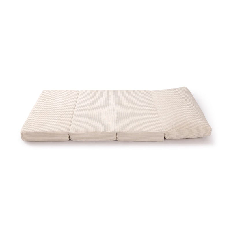 Foldable beige floor mattress for comfortable seating and sleeping.