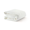 Folded white blanket on a plain background, showcasing a soft and cozy texture ideal for comfort and warmth.