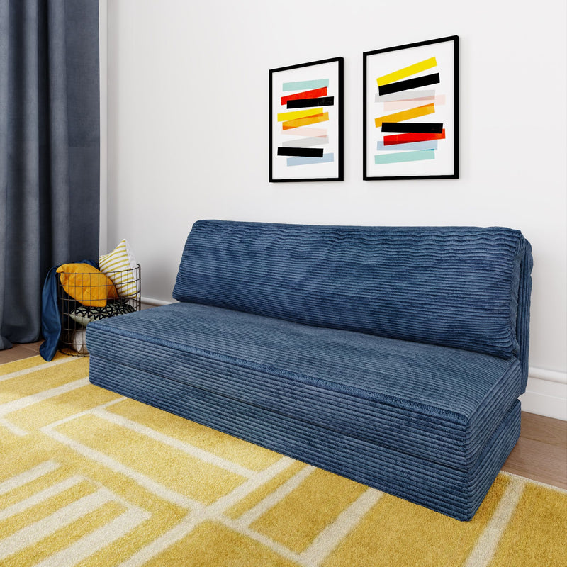 Modern living room with a blue corduroy sofa, abstract art on the wall, and a yellow geometric rug.