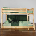 Natural pine wooden bunk bed with right-side ladder, green gingham and solid green bedding, plush pillows and dark green headboard panels on hardwood floor in a modern kids' bedroom