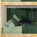 Wooden bunk bed with green bedding, dark green upholstered headboard, gingham pillow and round cushion
