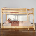 Light natural wood bunk bed with ladder, pink gingham bedding and throw pillows in a modern kids' bedroom on hardwood floors