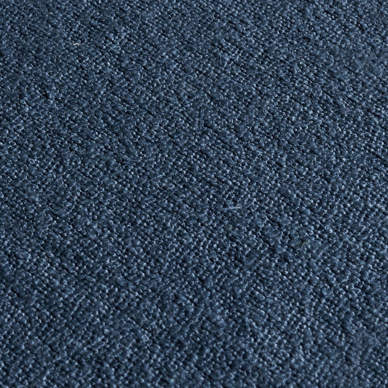 Close-up of dark navy textured bouclé upholstery fabric showing looped pile and woven texture for sofas, cushions, and carpeting