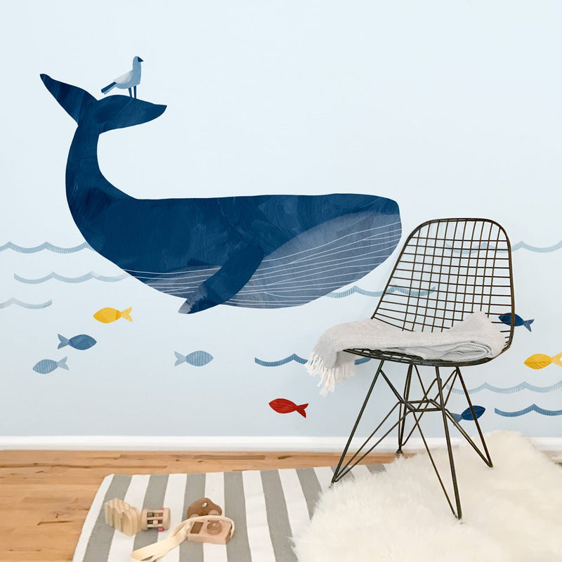 Blue whale nursery wall decal with colorful fish and waves — nautical kids' room decor and mural