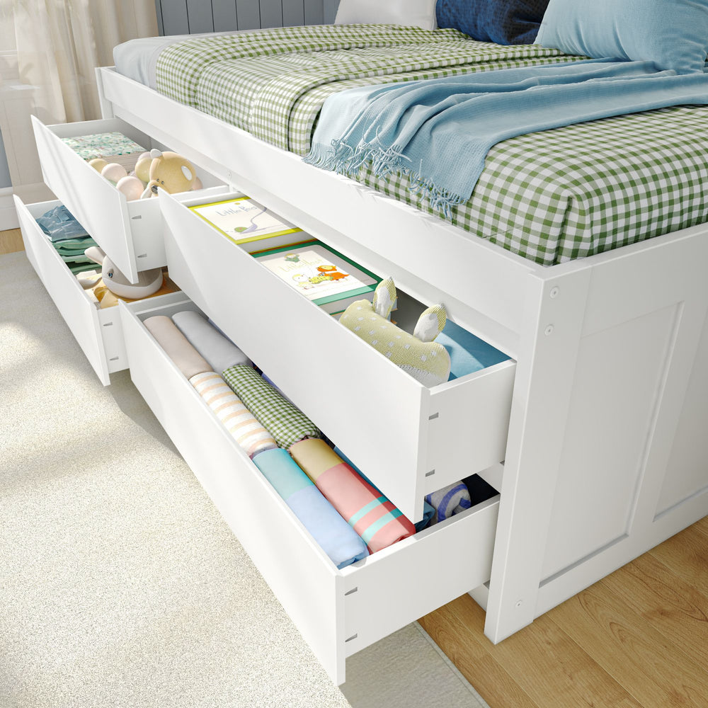 White platform bed with storage drawers, featuring neatly organized bedding, toys, and books, perfect for maximizing bedroom space.
