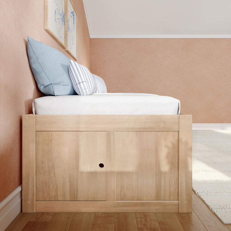 Cozy minimalist bedroom corner with light wood bed frame, blue striped pillows and framed butterfly art on a blush textured wall