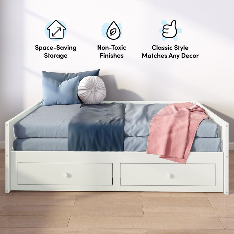 White wooden daybed with two under-bed storage drawers, blue bedding, pink throw and round pillow on hardwood floor, product image highlighting space-saving storage, non-toxic finishes and classic style