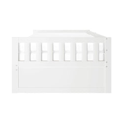White wooden toddler bed with safety guardrails.