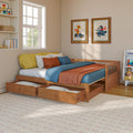Cozy kids bedroom with wooden bed, under-bed storage drawers, blue and orange bedding, animal wall art and sunlit window