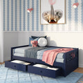 Navy twin daybed with under-bed storage drawers in blue and pink kids bedroom with elephant wall art, plush toy, and scalloped wallpaper