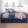 Navy blue daybed with two built-in under-bed storage drawers, light blue bedding, pink throw and round pillow — space-saving, non-toxic finish, classic bedroom style