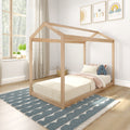 Scandinavian-style kids bedroom with natural wood house-frame bed, neutral bedding, blue patterned rug, window plants and playful framed wall art