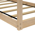 Close-up of light wood slatted bed frame (platform bed base) with center support strap and corner post, natural wood finish
