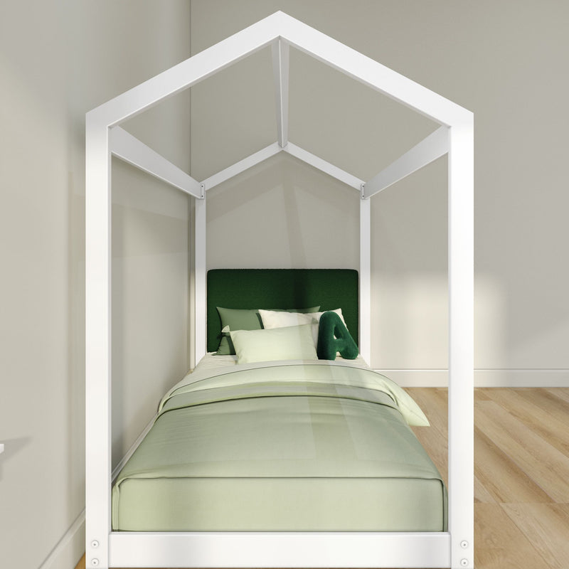 Modern white house-frame kids bed with green upholstered headboard and pastel green bedding in minimalist bedroom with hardwood floor