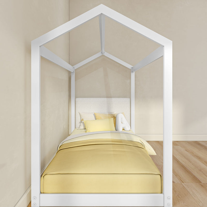Modern white house-shaped kids bed frame with yellow bedding and pillows in a minimalist nursery on hardwood floors