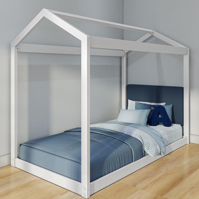 White wooden house-frame twin bed with blue bedding and pillows in a modern kids' bedroom on hardwood floor