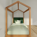 Minimalist house-shaped wooden canopy kids bed with green upholstered headboard and light green bedding in modern bedroom