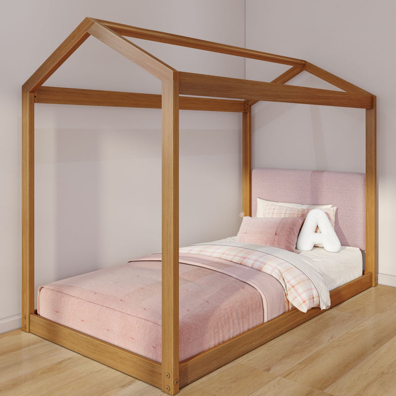 Solid wood house-shaped twin bed frame with pink upholstered headboard and pastel bedding in modern children's bedroom
