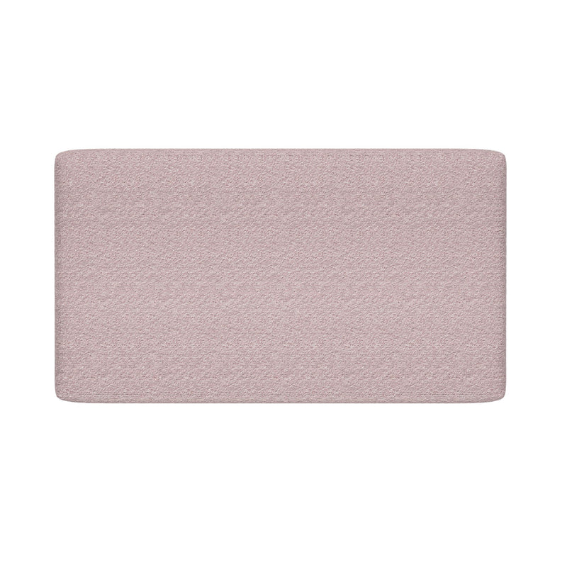 Light pink textured fabric upholstered headboard with rounded corners on white background, modern minimalist bedroom decor
