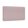 Blush pink upholstered headboard close-up showing textured fabric and rounded corners for a modern queen bed
