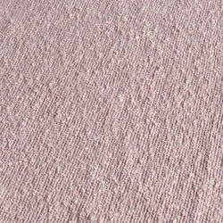 Close-up of blush pink boucle fabric texture with looped yarn and ribbed pattern for upholstery, rugs, and home decor