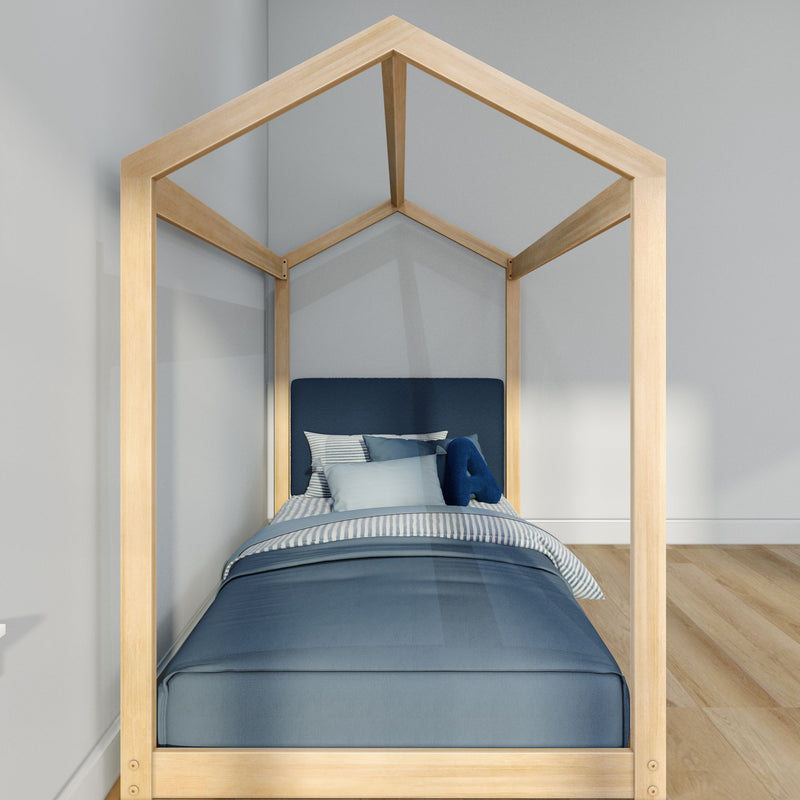 Modern house-shaped natural wood kids bed frame with navy-blue bedding and striped pillows in a minimalist children's bedroom