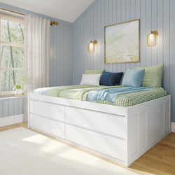 Modern cozy bedroom with white bed frame featuring built-in storage drawers, blue-green checkered bedding, and decorative cushions against light blue paneled walls and a scenic window view.