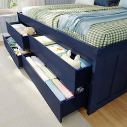 Blue storage bed with open drawers showcasing toys and neatly folded clothing, ideal for kids' bedroom organization.