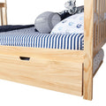 Natural pine children's bed with under-bed storage trundle drawer, navy blue striped fitted sheet, nautical anchor pillow, gray football cushion and plush tiger toy