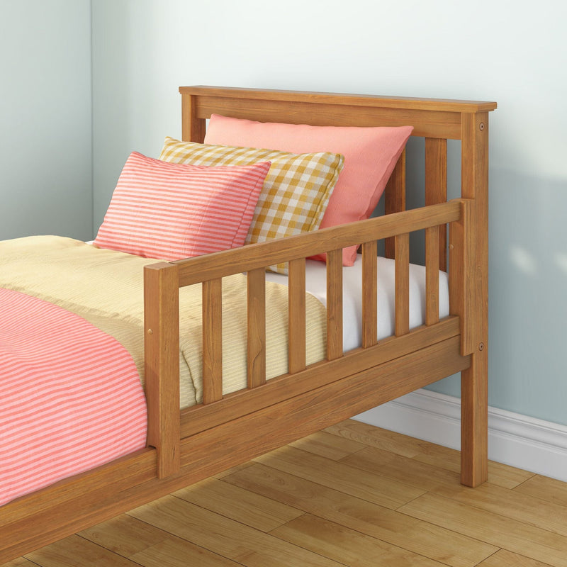 Light wood slatted bed frame with pink and yellow striped and gingham pillows, beige bedding on hardwood floor, modern bedroom décor