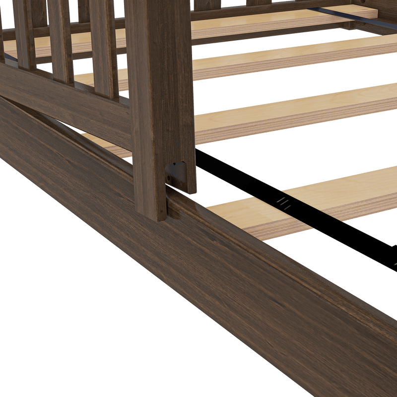 Close-up of dark walnut wooden bed frame with slatted plywood mattress support and black metal center rail, showing side rail and headboard post