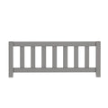 Gray wooden picket fence railing with evenly spaced vertical slats, modern outdoor garden railing for deck or porch