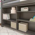 Dark wood bookshelf with woven storage baskets, pastel books, round storage boxes and retro tabletop radio — stylish nursery and kids room shelving organizer