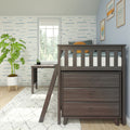 Dark wood loft bed in coastal nursery with blue wave wallpaper, window, potted plant and framed wall art