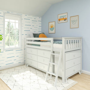 White loft bed with built-in drawers and ladder in a coastal-themed kids’ bedroom featuring blue wave wallpaper, surf prints, and natural window light