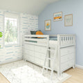 White loft bed with built-in drawers and ladder in a coastal-themed kids’ bedroom featuring blue wave wallpaper, surf prints, and natural window light