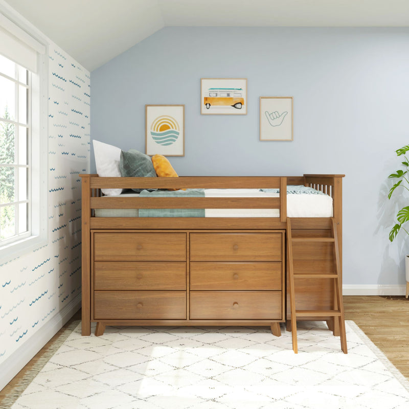 Natural wood kids loft bed with built-in drawers and ladder in coastal-themed nursery, light blue accent wall, framed beach prints and bright window light