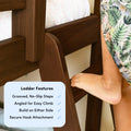 Close-up of a child's foot on a dark wood bunk bed ladder showing grooved no-slip steps, angled rungs for easy climb, secure hook attachment and reversible build-on-either-side design for kids' bedroom safety