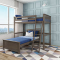 Solid wood twin-over-twin bunk bed with ladder and navy-blue bedding in a bright children's bedroom with large window, pale-blue paneled wall and geometric rug