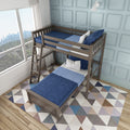 Modern wooden twin-over-twin bunk bed in a bright kids' bedroom with navy blue bedding, ladder, geometric area rug, light blue paneled wall and large window city view