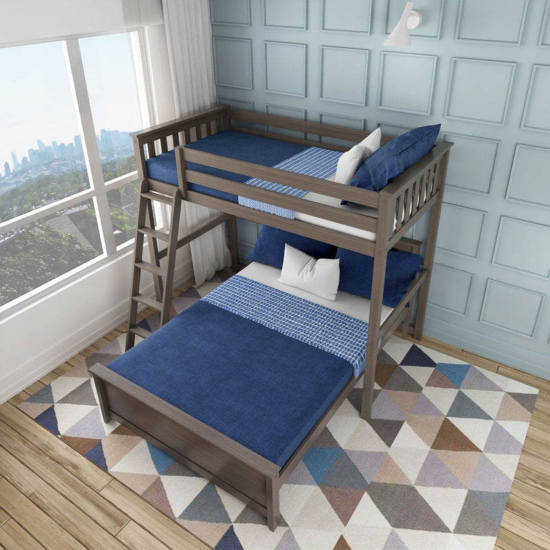 Wooden twin-over-full bunk bed with navy blue bedding and ladder in kids' bedroom, geometric rug and city skyline window view