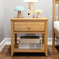 Modern oak bedside table with single drawer, pastel mushroom lamps and wooden birdhouse on top, woven storage boxes on lower shelf in a minimalist bedroom